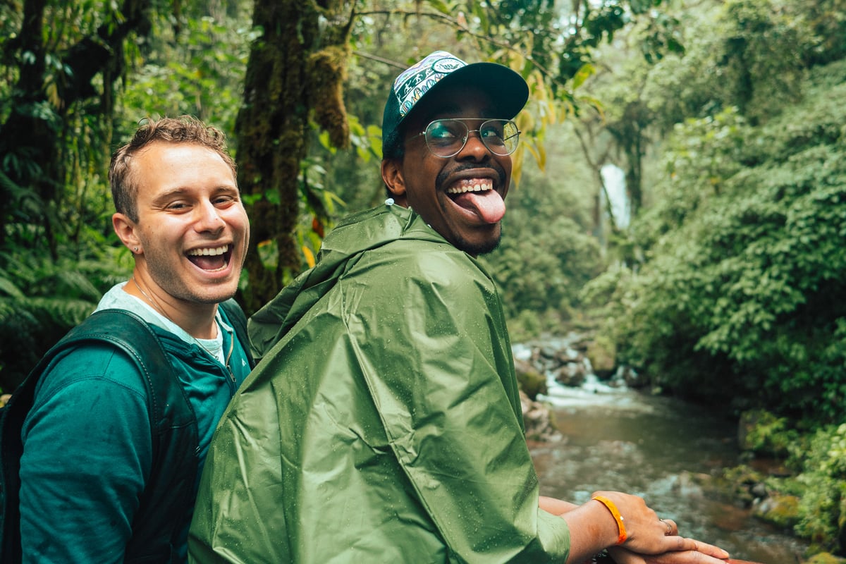 Couple smiling while hiking in a Costa Rican jungle.