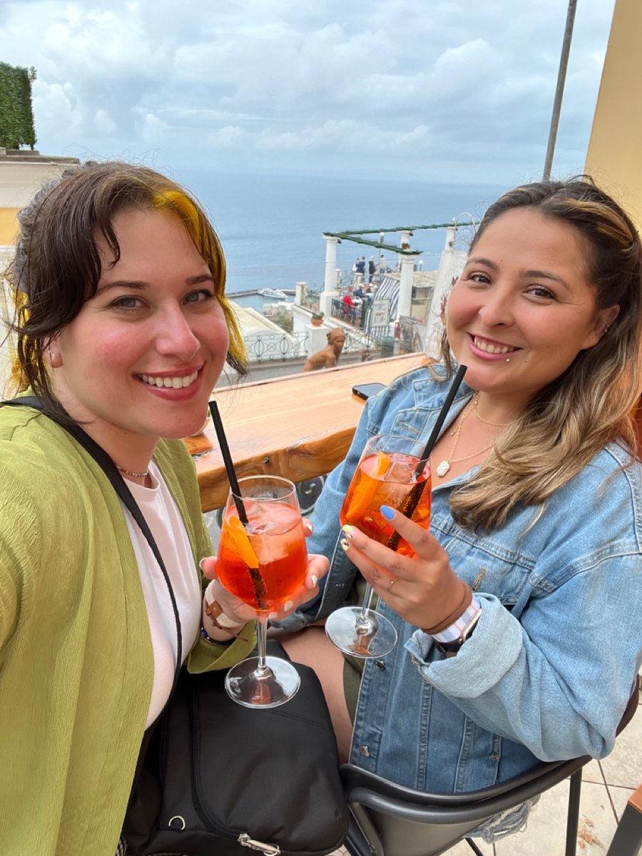 Friends sharing Aperol Spritz cocktails on the Amalfi Coast in Southern Italy.