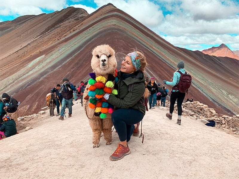 Outdoor influencer Brooke Willson with alpaca at Rainbow Mountain, Peru.