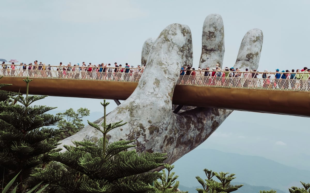 Tourists exploring Golden Bridge in Vietnam. 