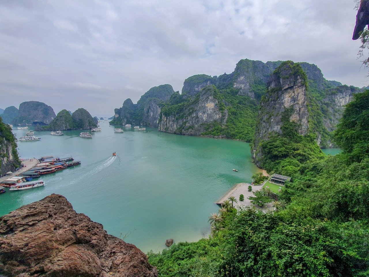View of water with a boat heading towards islands in Vietnam.